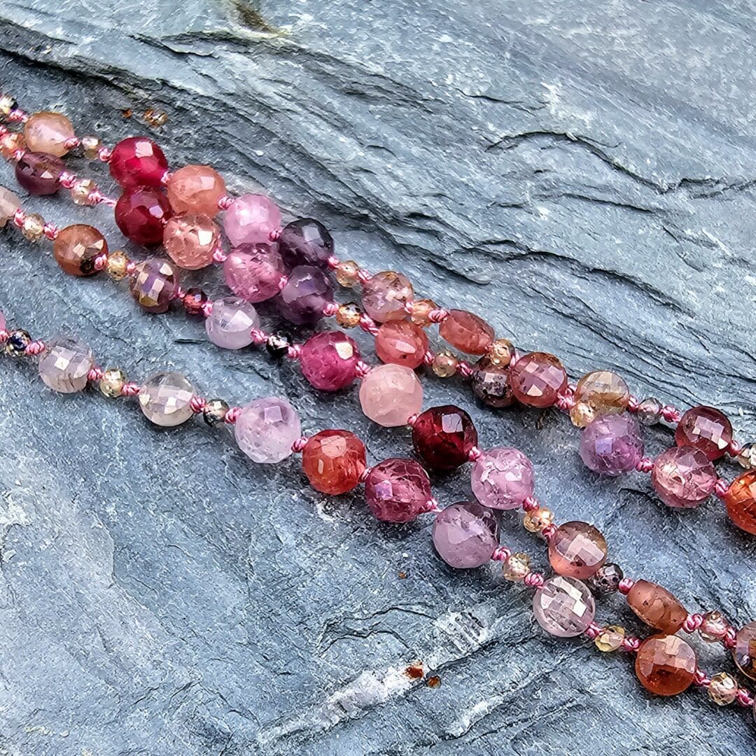 Spinel bead necklace with an etched silver flower pendant set with a small lab ruby at the centre, beads, Isobel Kelly Jewellery