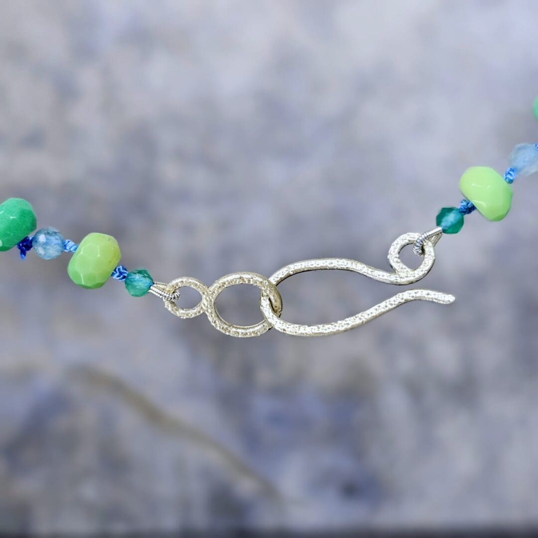 Silver leaf pendant set with lab emerald, topaz, tsavorite and spinel, clasp, Isobel Kelly Jewellery