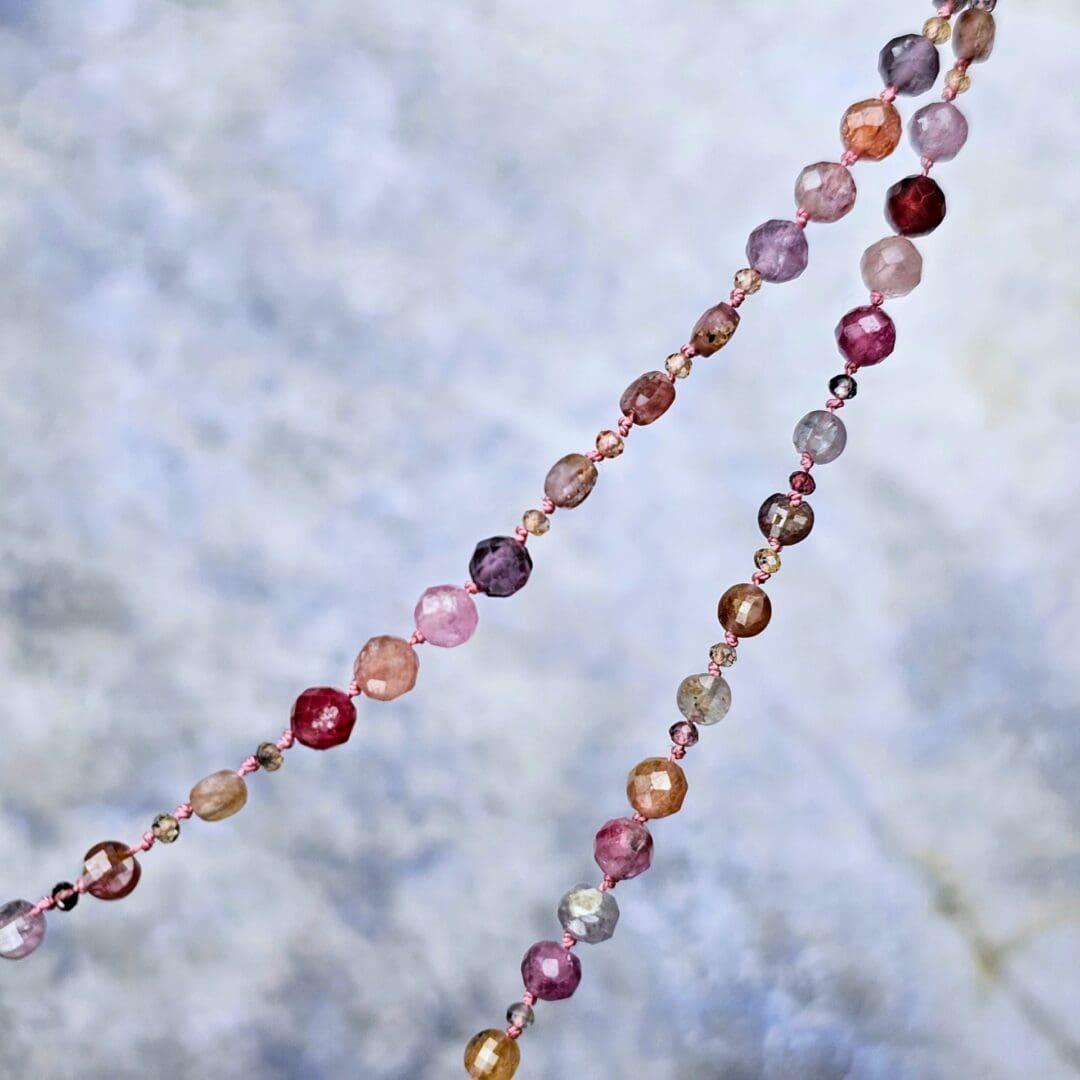 Spinel bead necklace with an etched silver flower pendant set with a small lab ruby at the centre, bead detail, Isobel Kelly Jewellery
