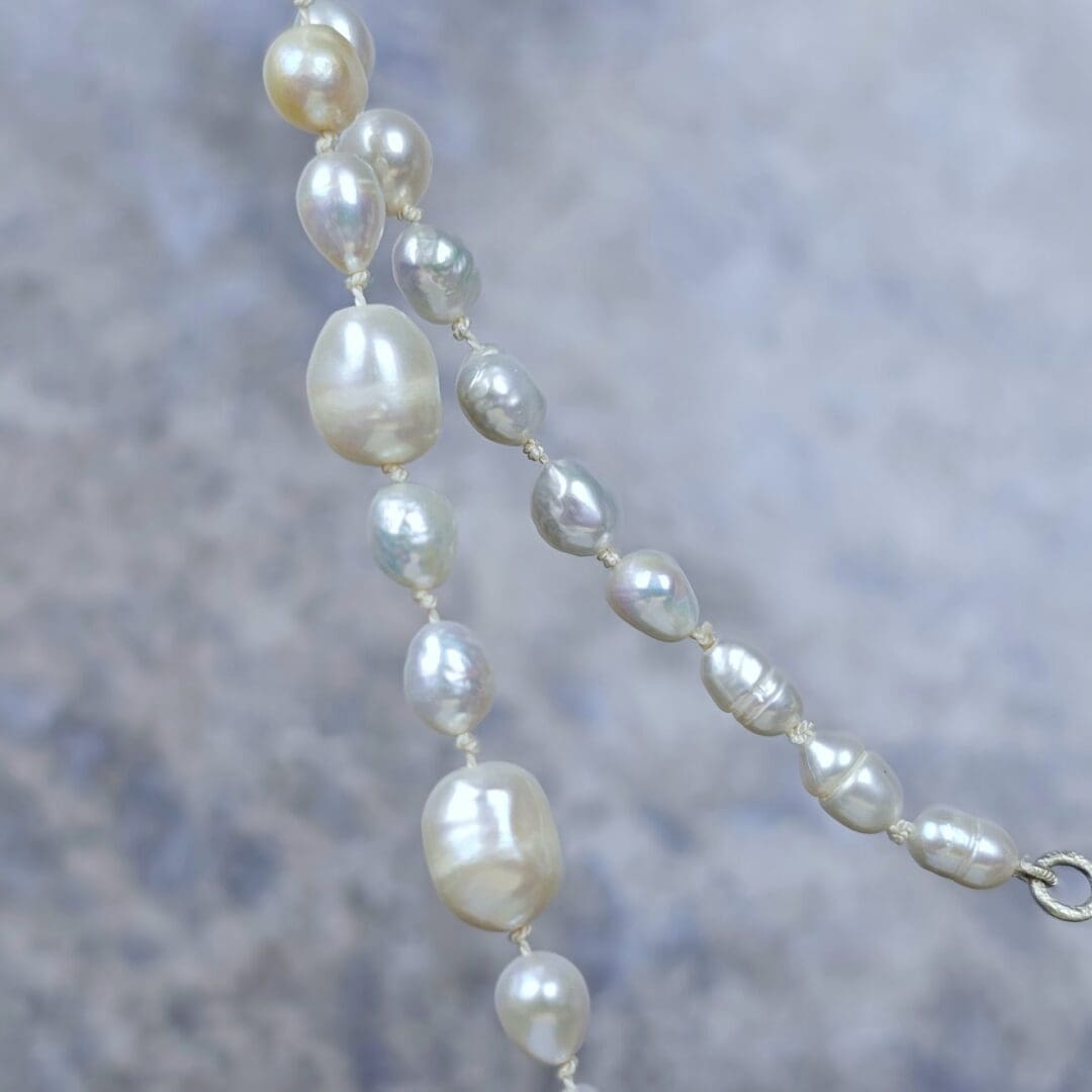 White baroque pearl necklace with a small etched silver heart pendant on a silk knotted strand, bead detail, Isobel Kelly Jewellery