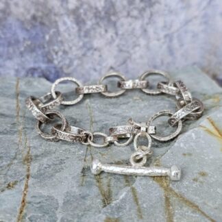 Chunky silver chain bracelet with hand etched leafy patterns and a forged toggle clasp, antique finish, Isobel Kelly Jewellery