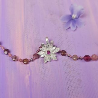 Spinel bead necklace with an etched silver flower pendant set with a small lab ruby at the centre, flower charm, Isobel Kelly Jewellery