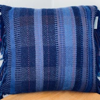 Contemporary hand woven wool cushion in a range of brilliant blues.