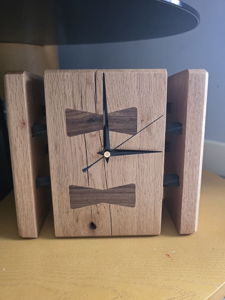 Sculptural oak mantel clock with natural splits and bow tie inlays