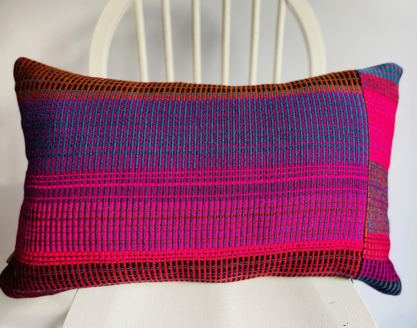 A colourful, patchwork design handwoven wool cushion - Image 2