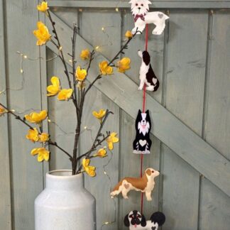 Wonderful Woofers felt dogs hanging decoration front view by lyndawilcansew hung against a slate grey wooden door with decorative vase and fairy lights