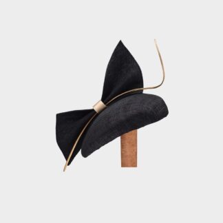black percher fascinator hat with large bow and gold feather quill