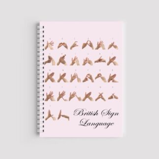 A spiral-bound A5 notebook with a pale pink cover featuring photos of hands demonstrating the British Sign Language (BSL) fingerspelling alphabet from A to Y. The words "British Sign Language" are written in an elegant script font at the bottom.