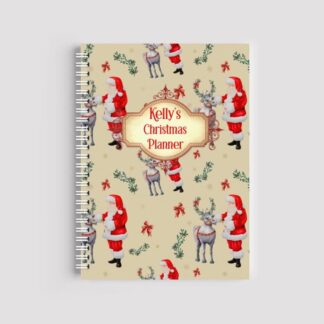A spiral-bound notebook with a cream background and a repeating pattern of Santa Claus with a reindeer, holly, and red bows. A central ornate label reads "Kelly's Christmas Planner" in red text.