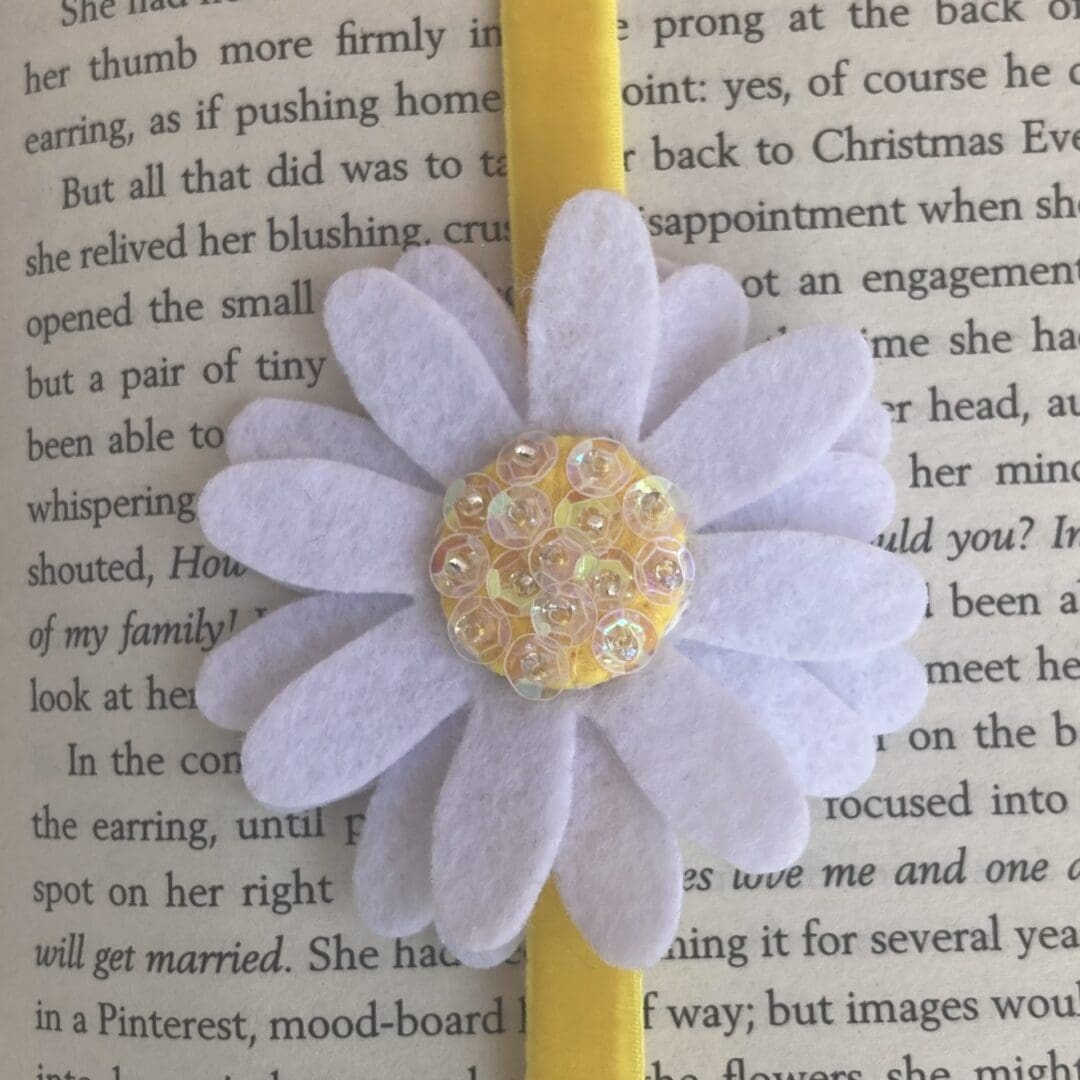 Close up of the felt daisy showing all of the sequins in the centre of the daisy