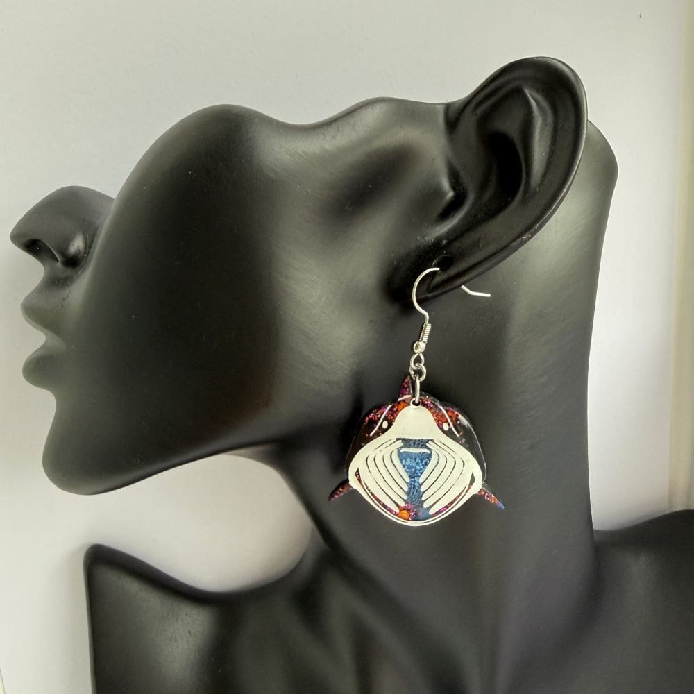 Lifestyle shot of Basking shark earrings shown on a bust for scale.
