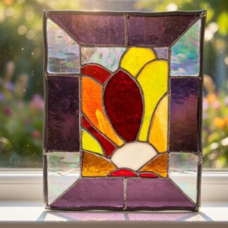 Freestanding stained glass tulip panel on a sunny windowsill