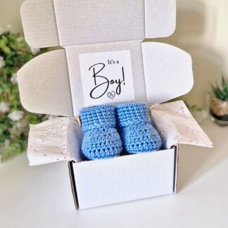 baby boy gender reveal with handmade crochet baby booties