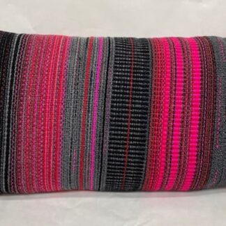 Contemporary hand woven wool cushion in a range of warm reds, soft greys and hot pinks.