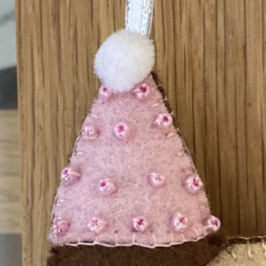 The party hat can be pink and adorned with pink beads