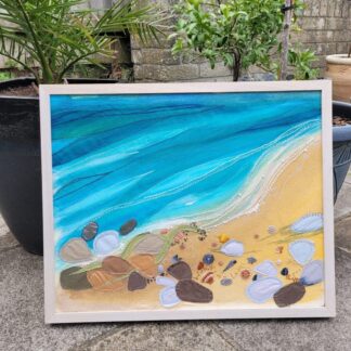 Large framed embroidery featuring shells and pebbles on the shoreline. 45 x 47 cm
