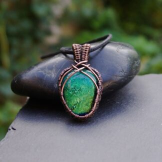 Handcrafted copper wire wrapped pendant with green dichroic glass cabochon