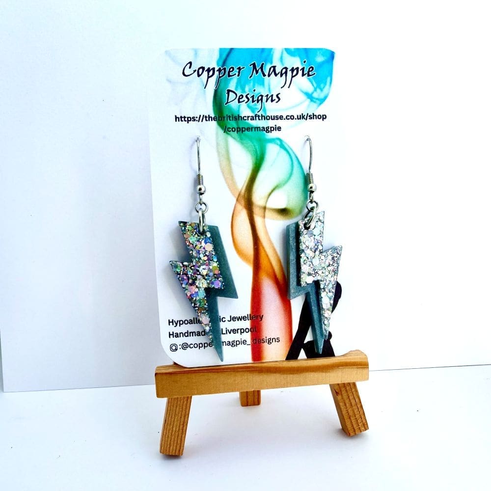 Silver rainbow resin lightning bolt earrings, displayed on a branded Copper Magpie Designs Card.