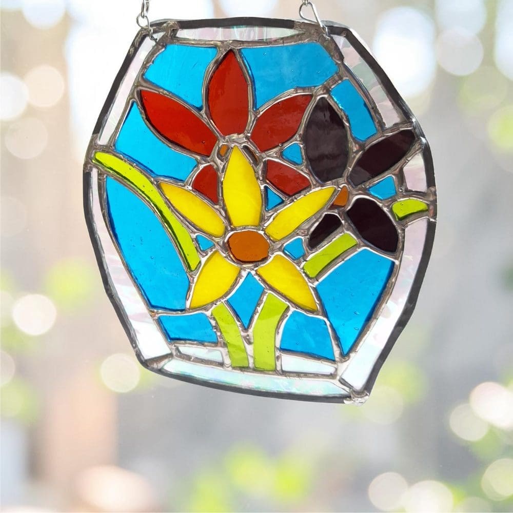 loral stained glass suncatcher catching sunlight in a cottage window
